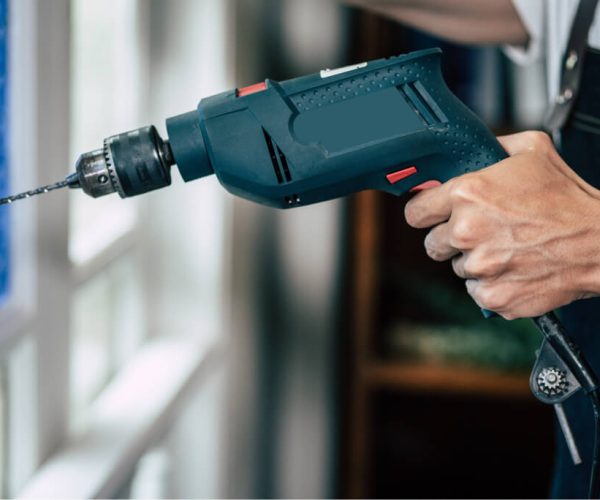 the-carpenter-holds-the-drill-and-drills-the-windo-2021-08-31-12-07-23-utc